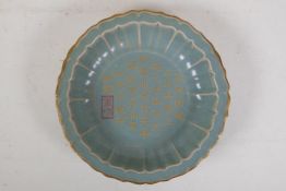 A Chinese Ru ware style porcelain bowl of lobed form, with a gilt rim and chased character