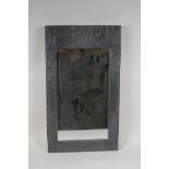 An Arts and Crafts design embossed pewter framed mirror