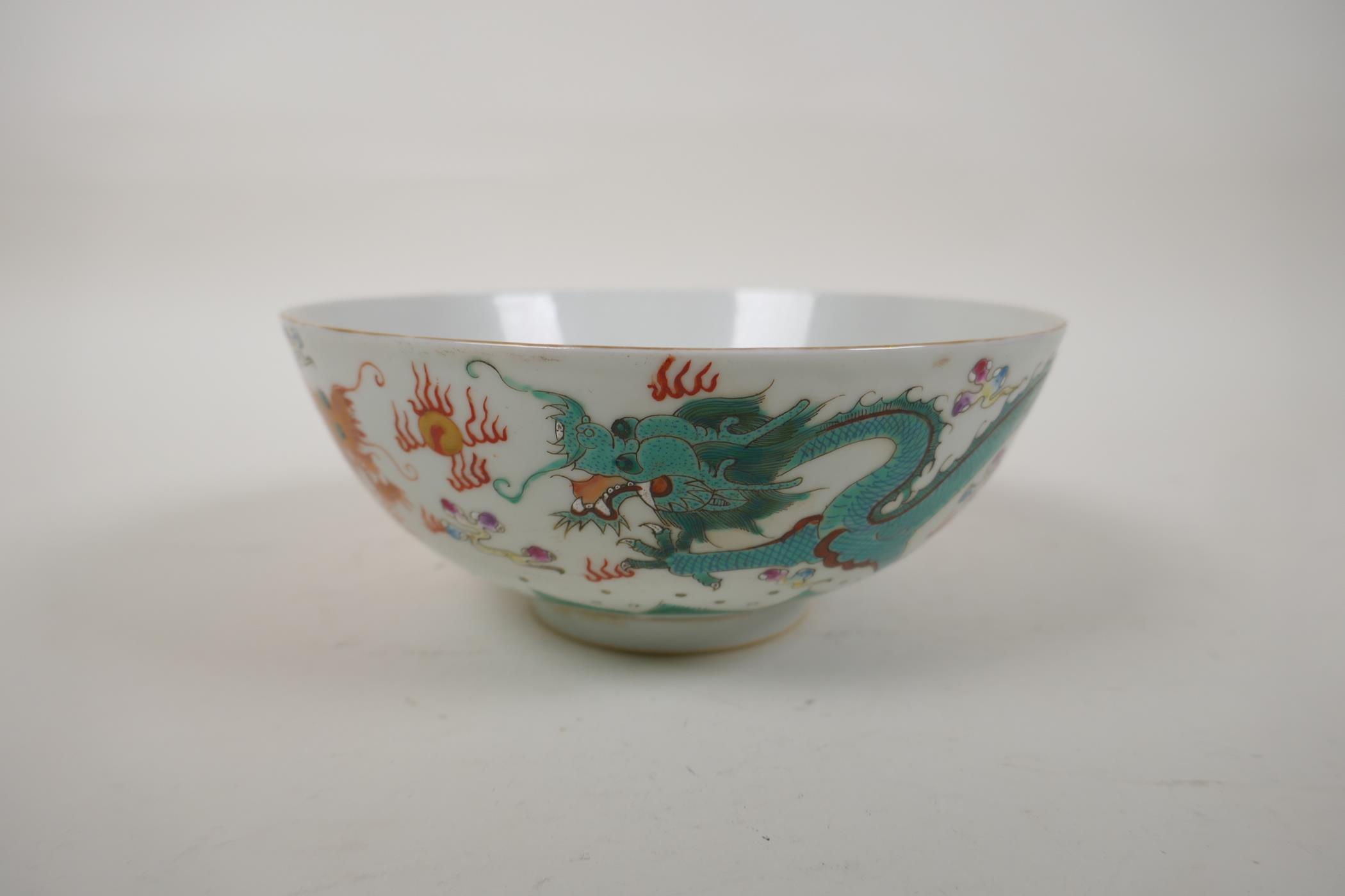 A polychrome porcelain bowl decorated with an iron red and green dragon chasing the flaming pearl, - Image 2 of 14