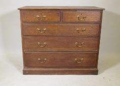 An oak chest, two + three drawers, with moulded fronts and brass swan neck handles, raised on a