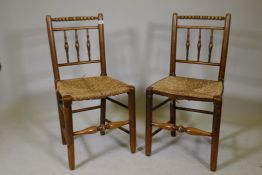 A pair of bobbin turned ash side chairs with woven rush seats