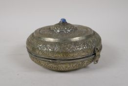A Sino Tibetan white metal box and cover with repousse decoration, 6" diameter
