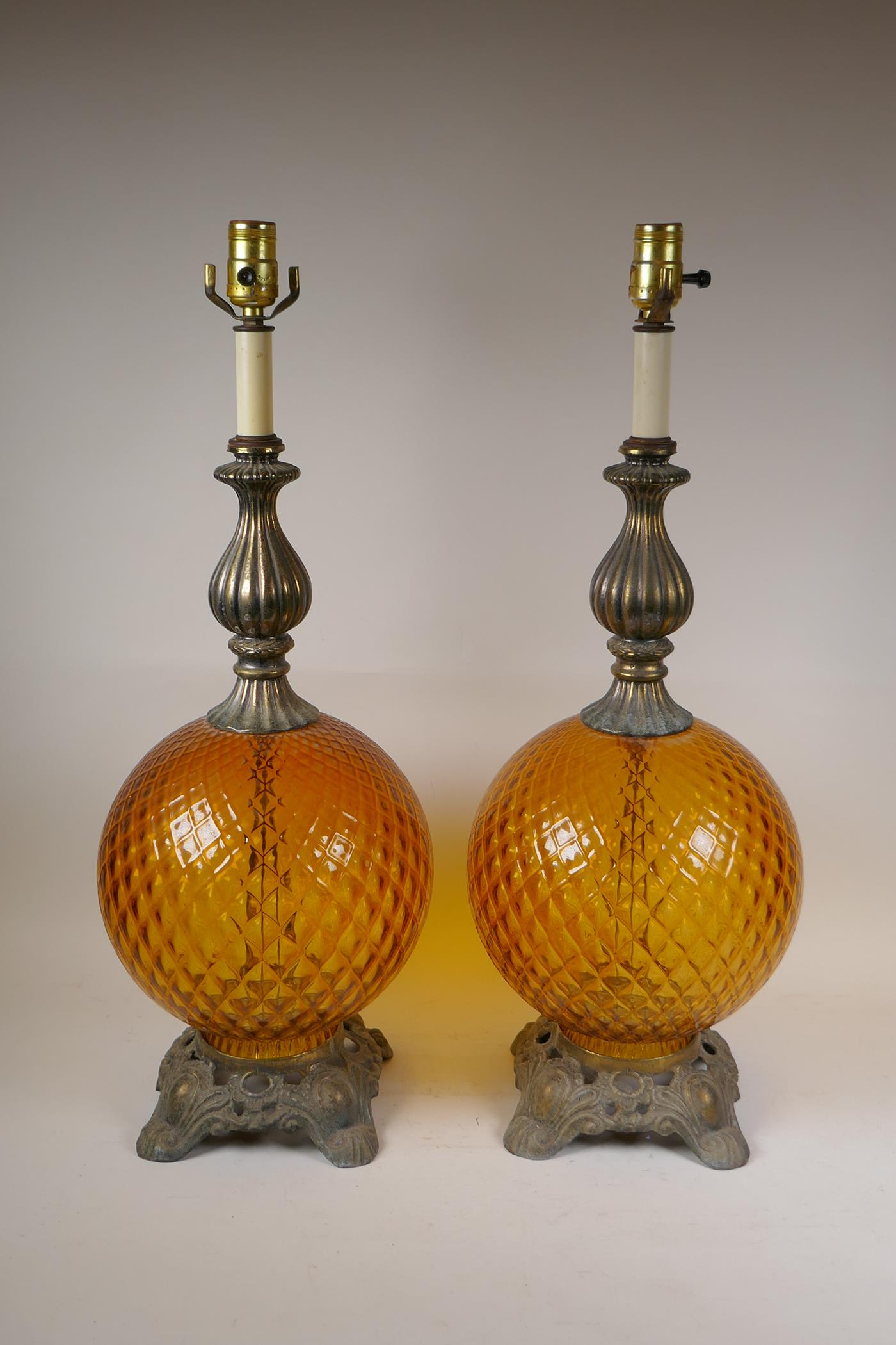 A pair of amber glass and gilt metal mounted lamps, 26" high