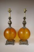 A pair of amber glass and gilt metal mounted lamps, 26" high