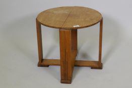 An Art Deco mahogany occasional table on plank supports and cross stretcher, 16½" x 19" diameter
