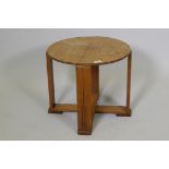 An Art Deco mahogany occasional table on plank supports and cross stretcher, 16½" x 19" diameter