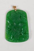 A Chinese apple jade pendant with carved wrathful figure decoration, gilt metal mount, 1½" x 2"