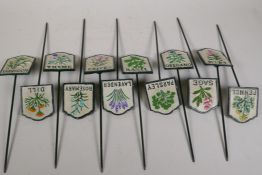 A set of twelve painted cast iron herb markers, 3" x 2½", stakes 8½" long