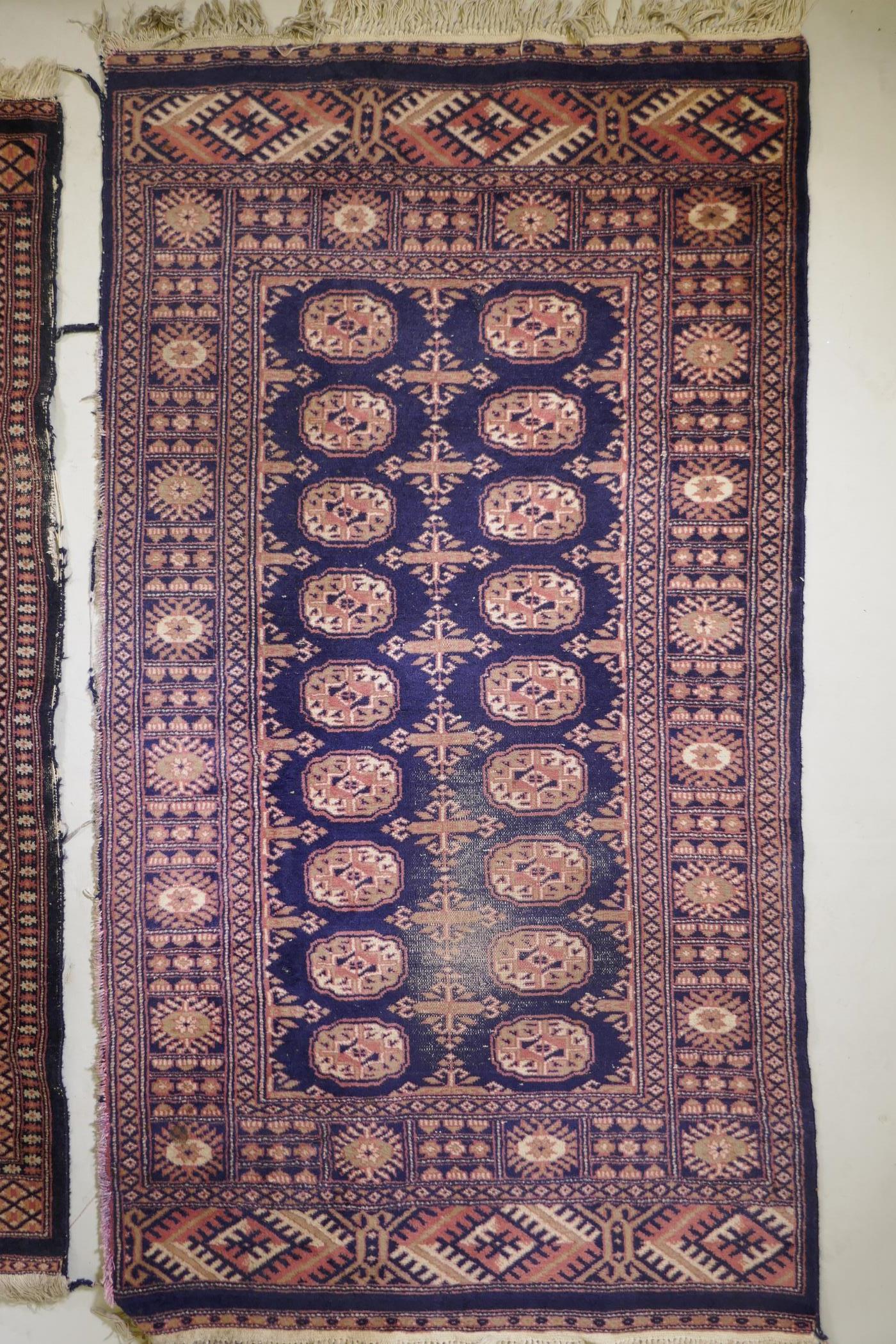 A Turkish blue ground Bokhara rug, a similar black ground Bokhara rug and two others, largest 68" - Image 4 of 12