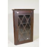 A Georgian oak hanging corner cabinet, with glazed door, 26" x 38"