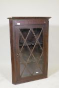 A Georgian oak hanging corner cabinet, with glazed door, 26" x 38"