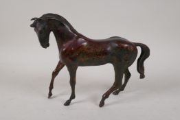 An oriental gilt bronze horse, 10" long, 8" high