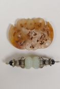 A Tibetan white metal and jade vajra style pendant and a Chinee carved hardstone pendant with dragon