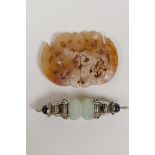 A Tibetan white metal and jade vajra style pendant and a Chinee carved hardstone pendant with dragon