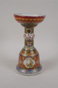A Chinese polychrome porcelain candlestick, decorated with auspicious symbols, flowers, birds etc, 4