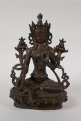 A Sino Tibetan bronze figure of Buddha seated on a lotus throne, with the remnants of gilt patina,