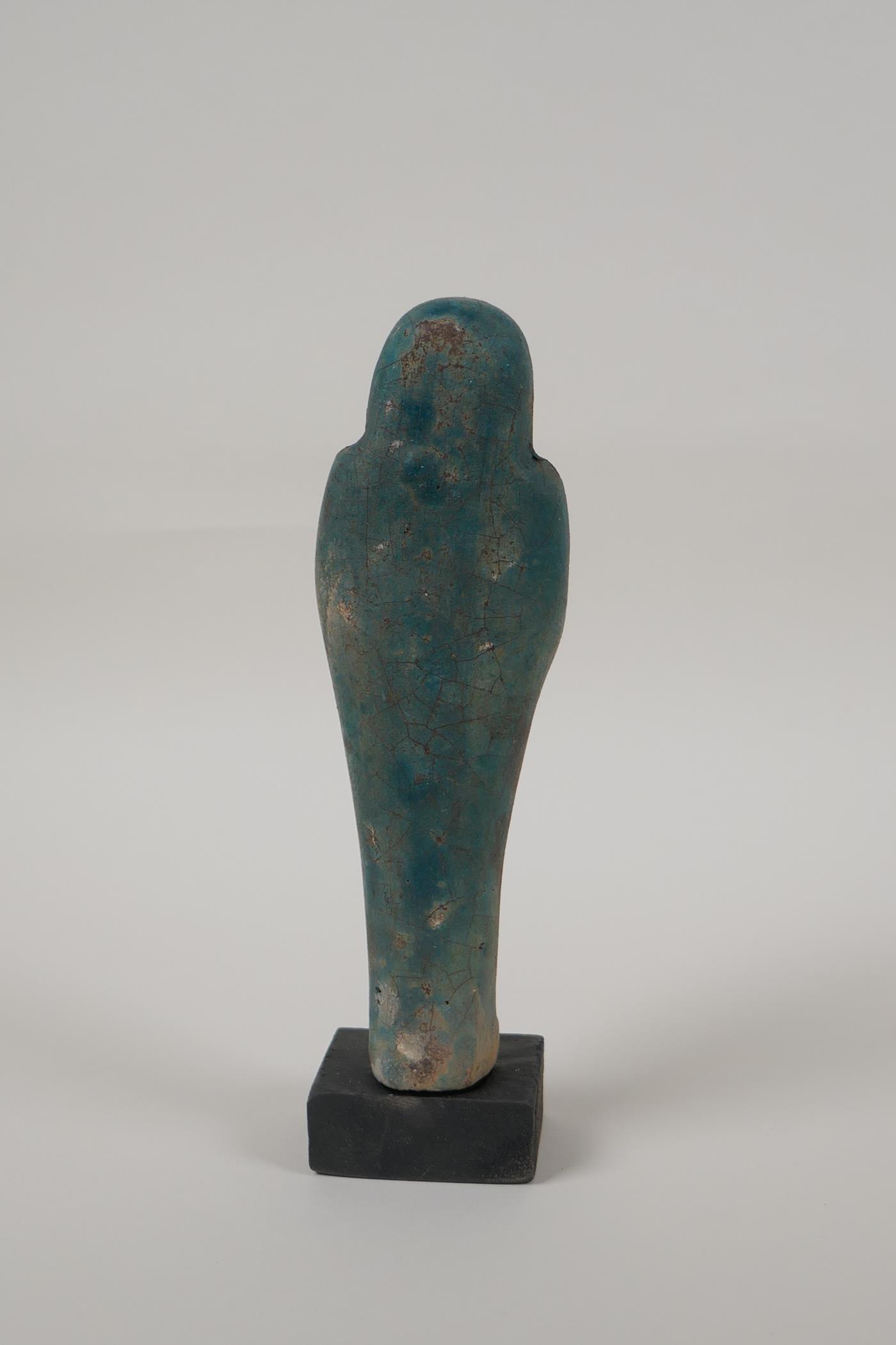 An Egyptian turquoise glazed faience shabti, mounted on a display base, 7" high - Image 4 of 5
