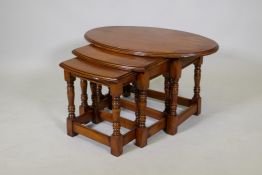 A nest of three beechwood shaped top occasional tables, 32" x 20" x 18"