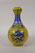 A yellow ground porcelain garlic head shaped vase with blue and white dragon decoration, Chinese
