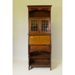 A Victorian inlaid mahogany bureau bookcase, the upper section with pierced frieze and open shelf