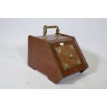 A Victorian walnut coat scuttle with brass mounts and handle, complete with shovel and metal