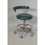 A vintage Adec dentist assistant's swivel stool with adjustable height and back/arm