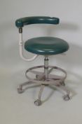 A vintage Adec dentist assistant's swivel stool with adjustable height and back/arm