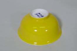 A Chinese yellow glazed bowl, painted six character mark to base, 4½" diameter