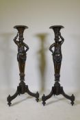 A pair of antique carved wood torcheres in the form of caryatids, with painted and parcel gilt