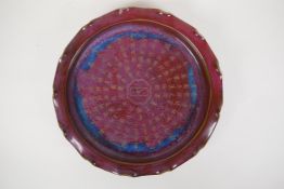 A Chinese Jun ware shallow dish/charger with frilled rim and chased character inscription