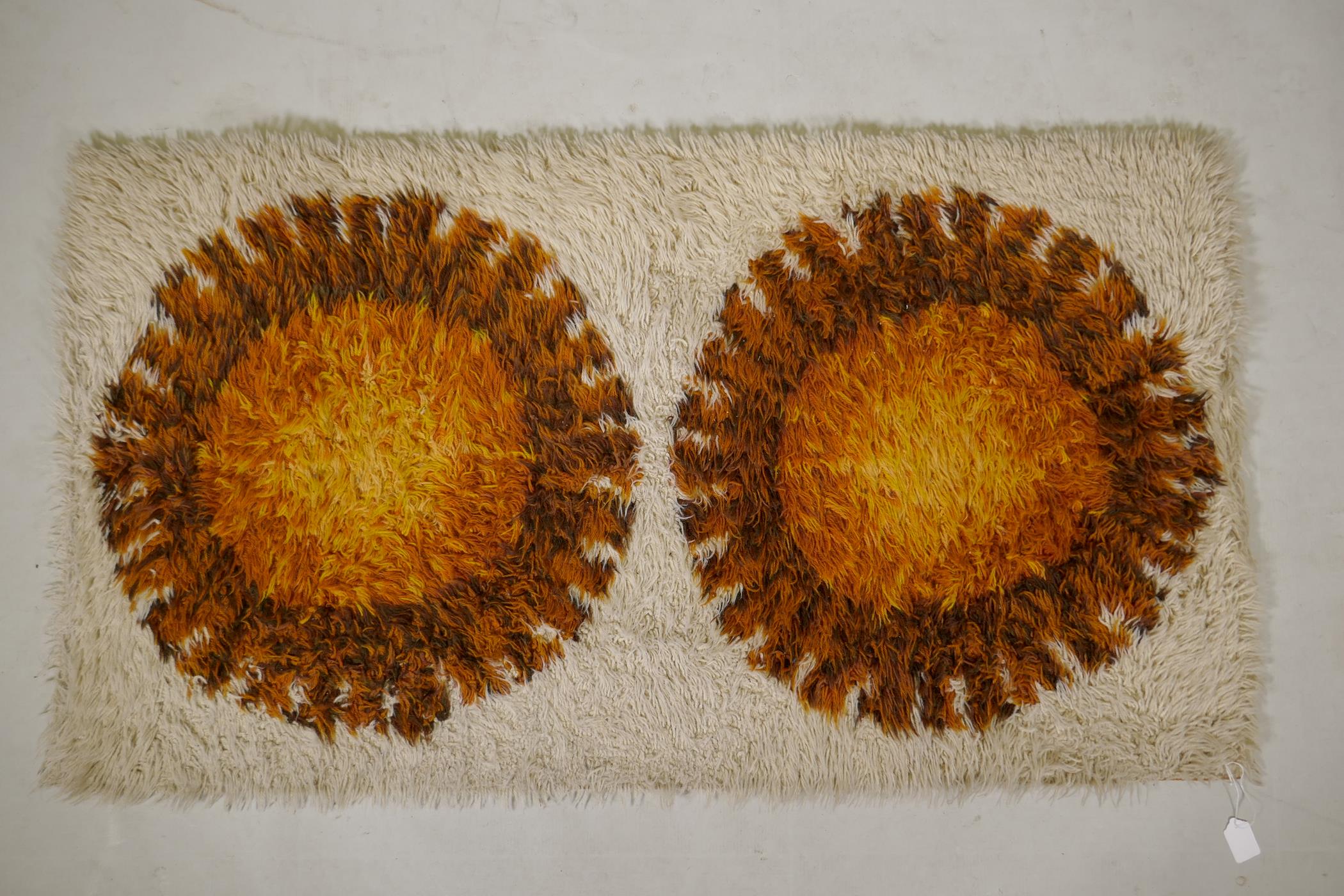 A 1970s cream ground shagpile Norsk rug, with a sunburst medallion design, 48" x 26"