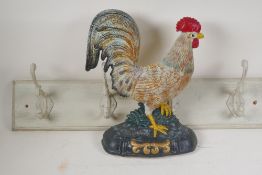 A painted cast iron cockerel doorstop, 13½" high, and a coat rack with four hooks, 28" long