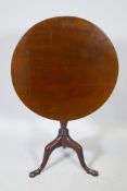 A Georgian mahogany tilt top occasional table on tripod supports, 29" high, 27" diameter