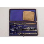 A cased technical drawing set and a silver plated cigarette box