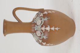 A Doulton stoneware jug of classical form with applied garland decoration