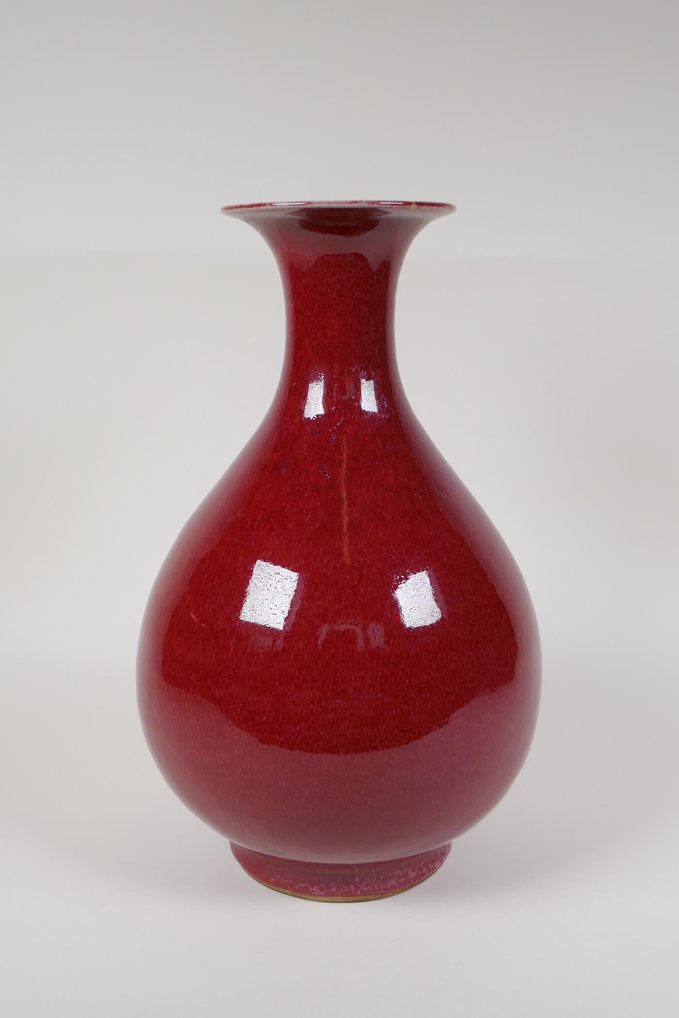 A Chinese flambe glazed porcelain pear shaped vase with flared rim, 13" high