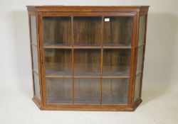 A C19th walnut hanging display cabinet, with canted ends and single door, 48" x 10" x 40"