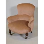 A Victorian upholstered tub chair on acanthus carved turned supports