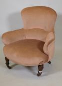 A Victorian upholstered tub chair on acanthus carved turned supports