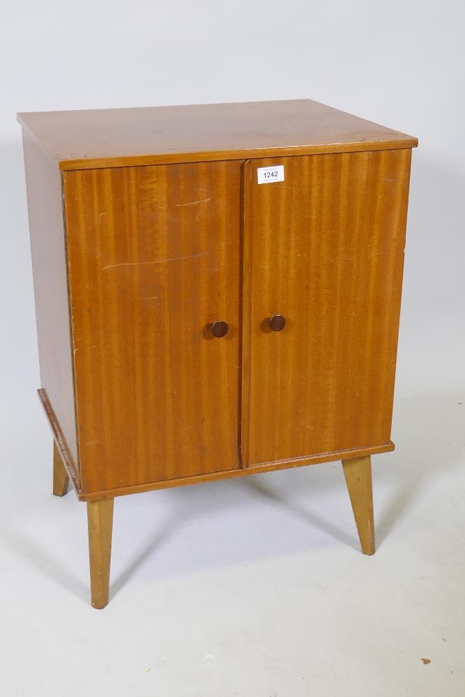 A mid century 'Arnold' sapele wood record cabinet, the interior fitted with drop down record holders