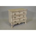 A small painted bombe shaped commode of three drawers, with shaped top, raised on paw feet, 30" x