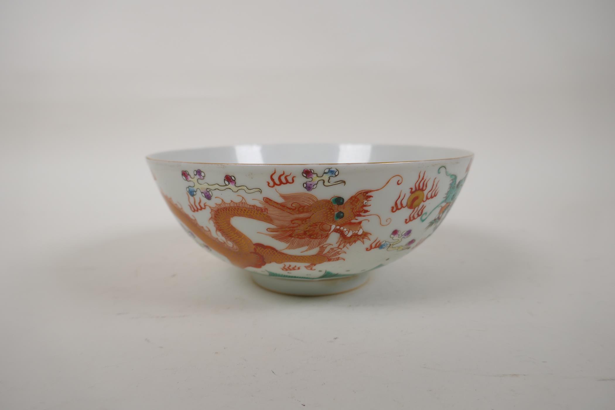 A polychrome porcelain bowl decorated with an iron red and green dragon chasing the flaming pearl, - Image 3 of 14