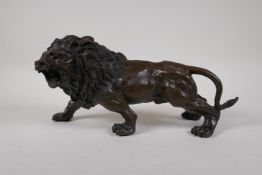 After Rodin, a cast bronze figure of a prowling lion, 12½" long