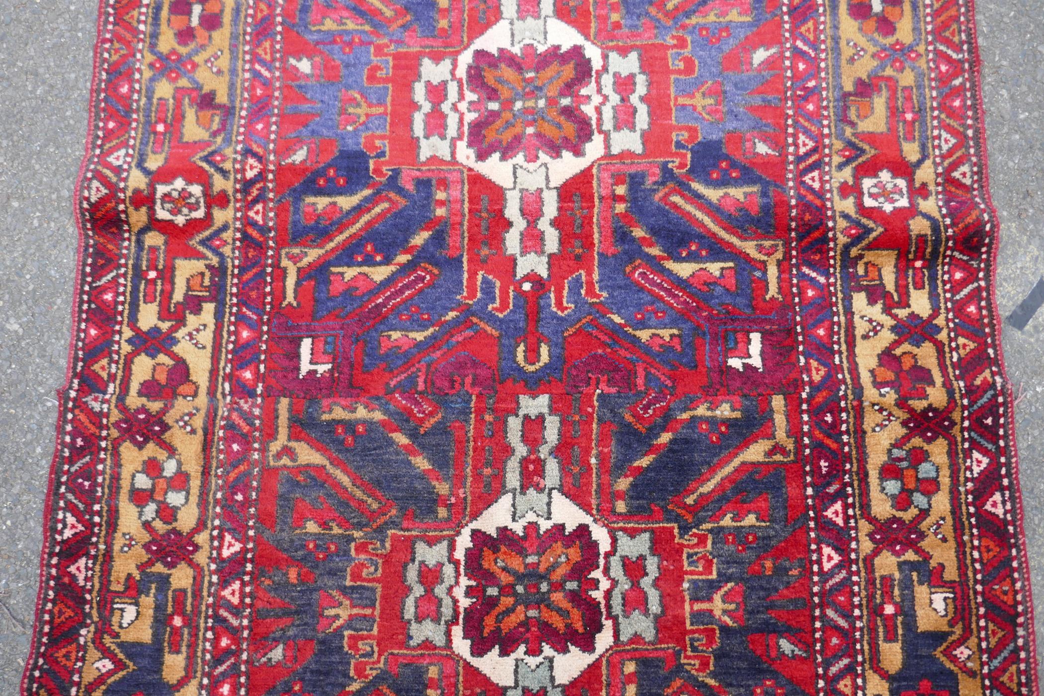 A Persian red ground Heritz runner with a starburst medallion design, 46" x 131" - Image 5 of 8