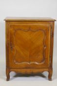 A C19th French side cabinet, with single door opening to reveal a shelf and two drawers, raised on