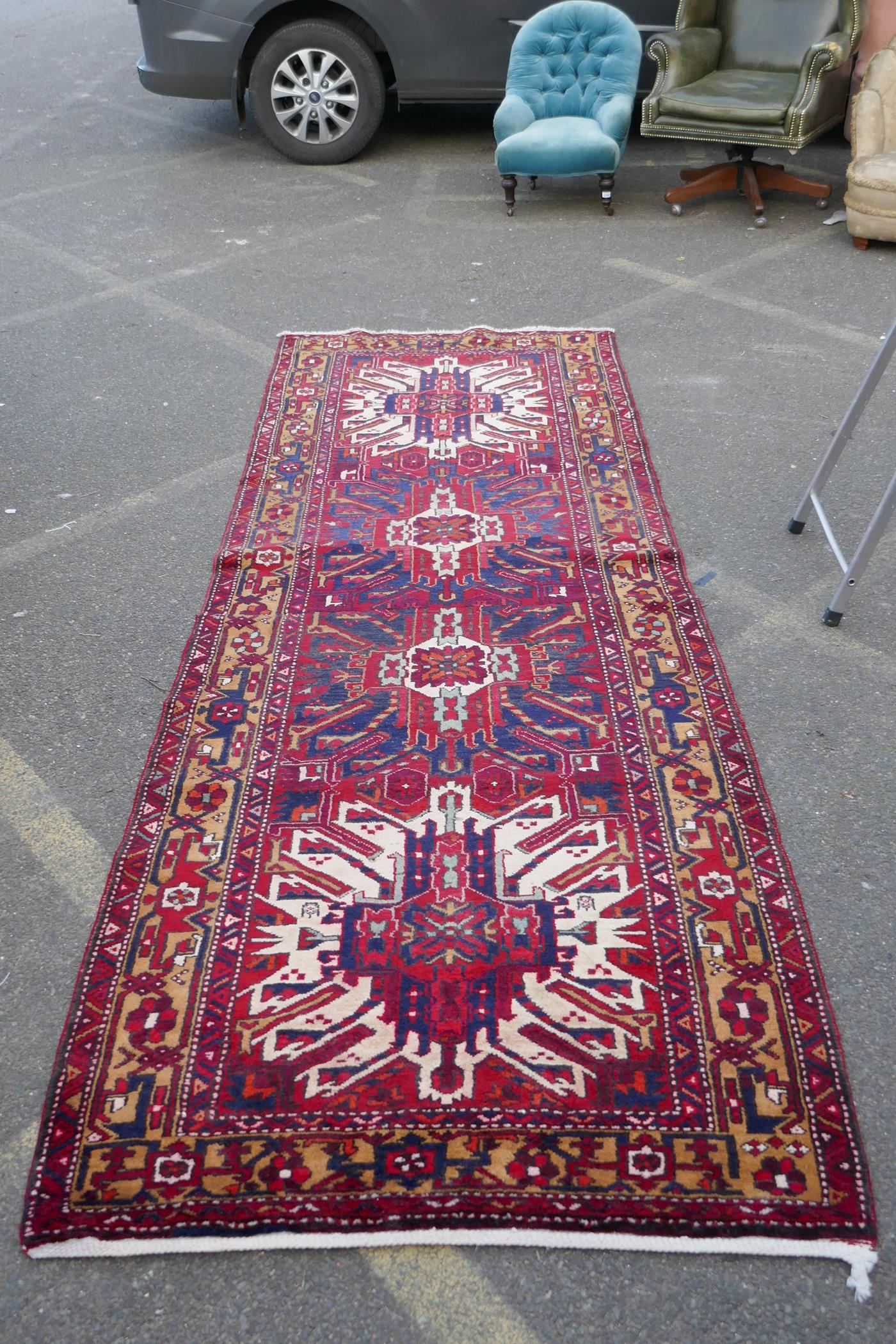 A Persian red ground Heritz runner with a starburst medallion design, 46" x 131" - Image 3 of 8