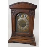 An Art Nouveau oak cased Westminster chimes mantel clock with brass dial, secondary dials,