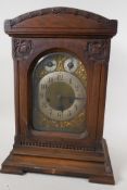 An Art Nouveau oak cased Westminster chimes mantel clock with brass dial, secondary dials,