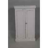 A white painted two door storage cabinet, 31½" x 19" x 10"
