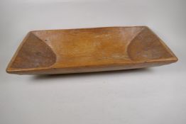 An elm dough bowl carved from a single log, 26" x 12"
